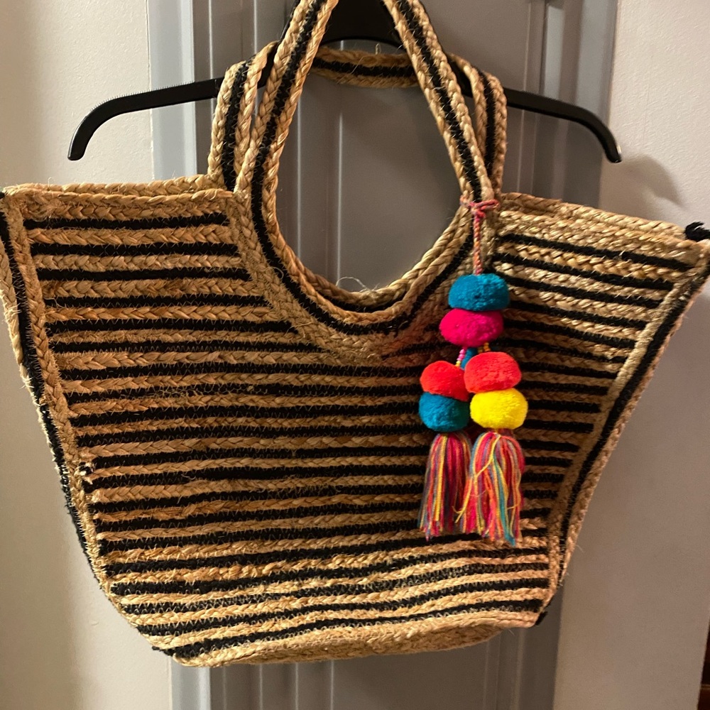 Great beach tote. Cute Pom Pom accents. Purchased from Stein Mart.